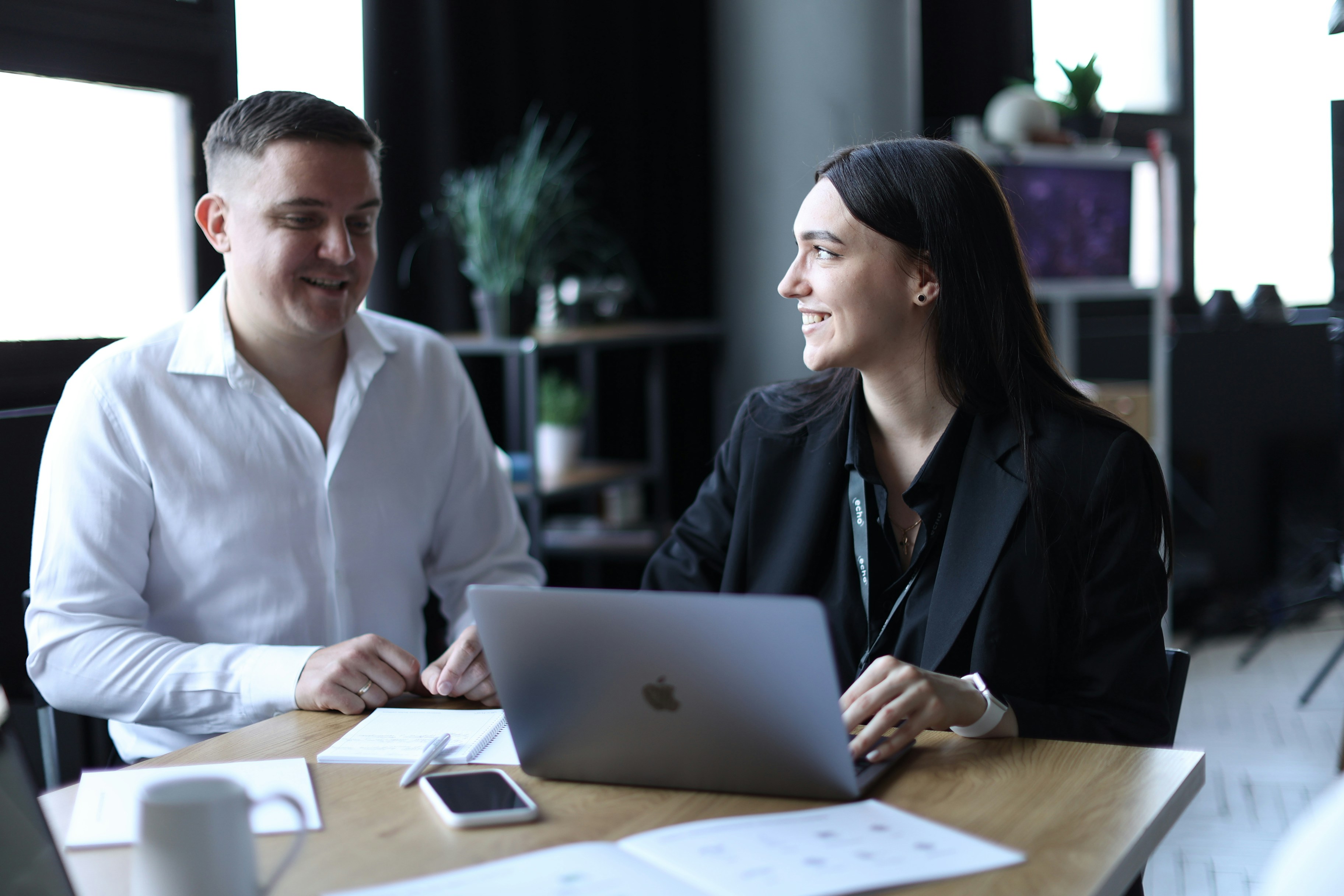 Man and Woman with Laptop and Reports